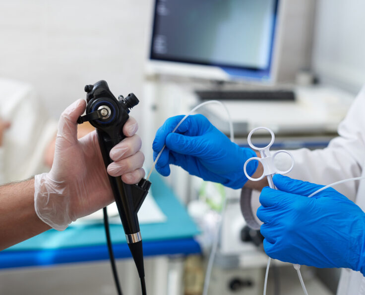 doctor puts a plaster on the arm of a patient in the hospital with a broken arm