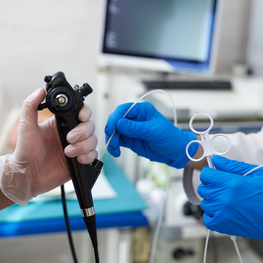 doctor puts a plaster on the arm of a patient in the hospital with a broken arm